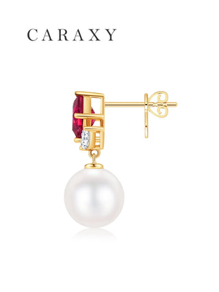 Side view of an 18K yellow gold pearl drop earring with red gemstone and marquise diamonds