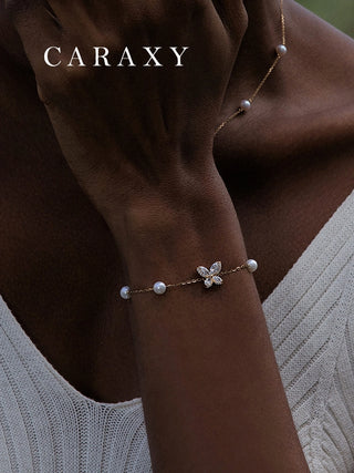 Model wearing a freshwater pearl and lab-grown diamond butterfly bracelet