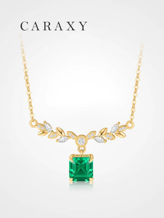 18K yellow gold emerald May birthstone necklace with Asscher cut lab created emerald and diamond leaf accents