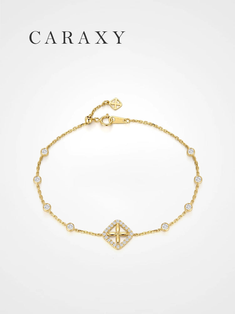 18K yellow gold lab grown diamond station bracelet with bezel-set round diamonds and a clover-inspired center motif.