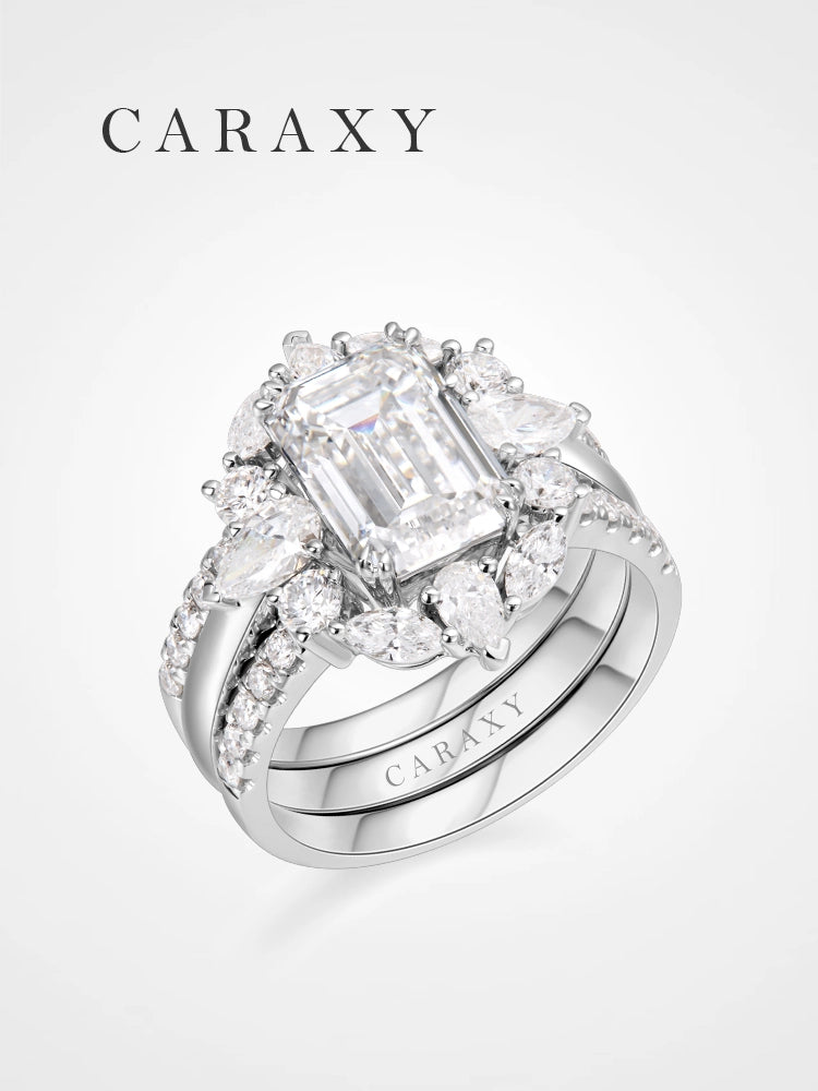 Perspective view of the emerald cut bridal set showing the 3 carat center stone and the tiered diamond cluster.
