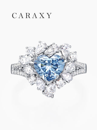 Top-down macro shot of the 1ct heart shaped blue diamond with a diamond halo cluster.