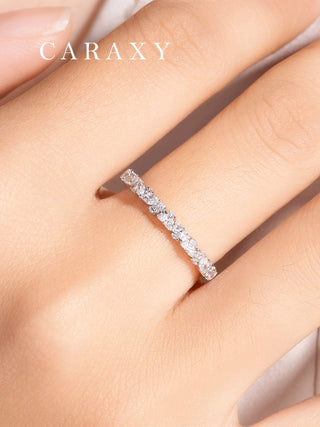 Close-up shot of the marquise wedding band in 18K white gold on a model's finger.