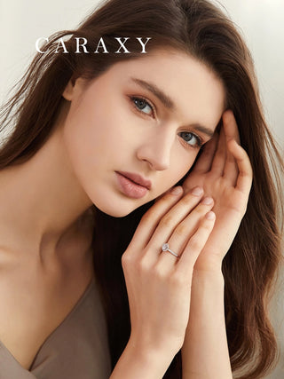 Close-up portrait of a model showcasing the sparkle and scale of the CARAXY proposal ring.