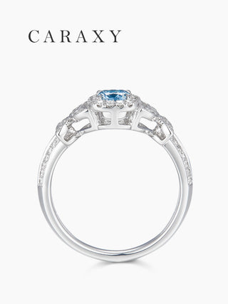 Side profile of the 18K white gold blue diamond ring showing the intricate butterfly wing filigree under the setting.