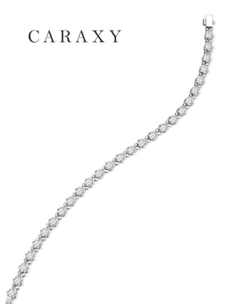 An S-curve arrangement of the Caraxy solid platinum clover diamond tennis bracelet on a white background.