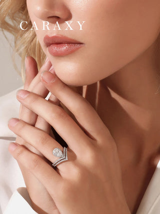 model-wearing-pear-cut-halo-and-chevron-wedding-bands