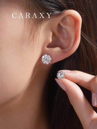 Model wearing the floral diamond stud earrings next to her hand to demonstrate scale and brilliance.