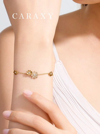 Close-up of a model wearing the dainty gold daisy diamond bracelet, showing the floral details against skin.