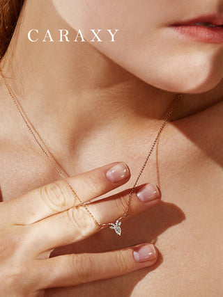 Detailed on-model view of an animal motif fine jewelry necklace with graceful lines and sparkling diamond accents.