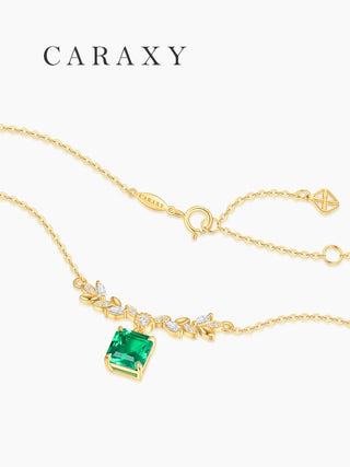 Back view of Asscher cut lab created emerald necklace showing adjustable chain, spring ring clasp, and CARAXY tag.