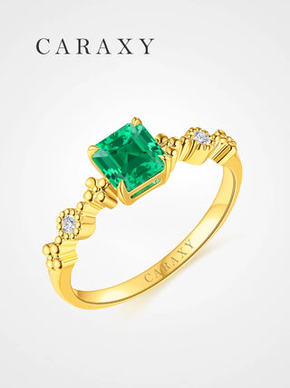 Asscher cut lab created emerald ring in 18K yellow gold.