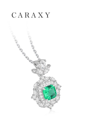 Side view of an asscher-cut muzo-green gemstone diamond pendant in 18K white gold