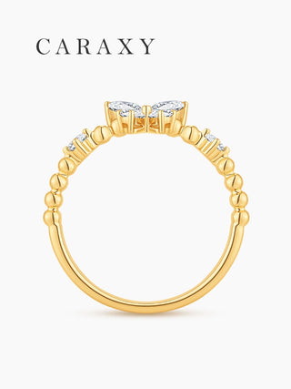 Side view of an 18K yellow gold butterfly diamond ring with beaded band details