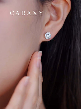 Bloom-inspired diamond stud earrings with round center stones and pavé accents.
