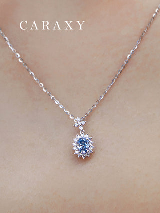 Blue diamond pendant necklace shown on a model for a close detail view.