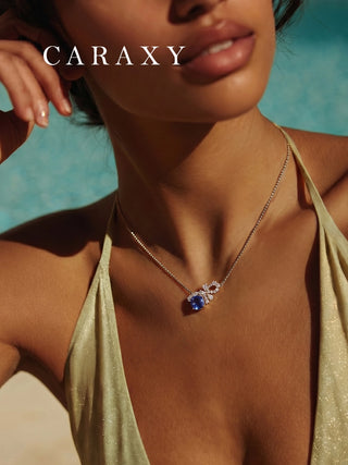 Model wearing a blue sapphire and lab-grown diamond bow necklace in 18K white gold