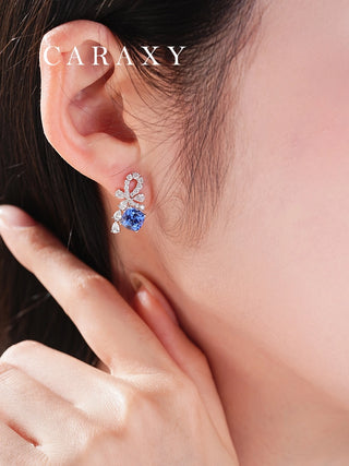 Close-up of bluebell-inspired sapphire earrings in 18K white gold.