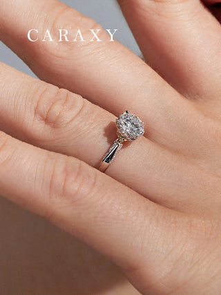 Close-up of a bouquet inspired diamond ring on finger highlighting the unique setting.