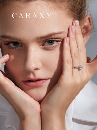Close-up of a bouquet inspired diamond ring on finger highlighting the unique setting.