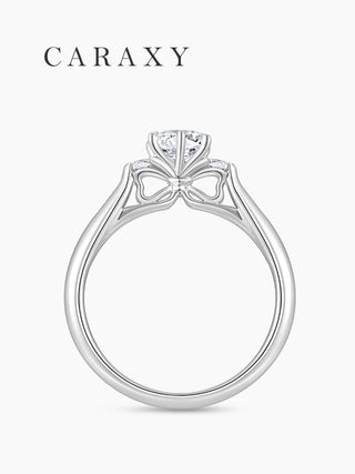 Side view of an engagement ring showcasing the unique bow-inspired setting.
