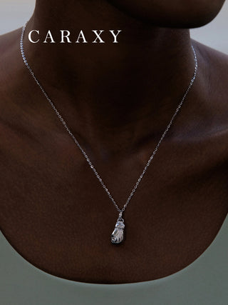 Model wearing a sterling silver boxing glove necklace with subtle lab grown diamond accents.