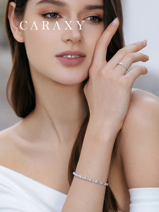 Model wearing an 18K white gold emerald-cut and round diamond tennis bracelet
