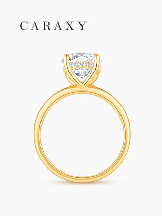 Profile view of an 18K yellow gold oval engagement ring with a four-prong gallery