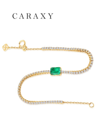 Full-length view of the adjustable 18K yellow gold lab-grown emerald and diamond tennis bracelet