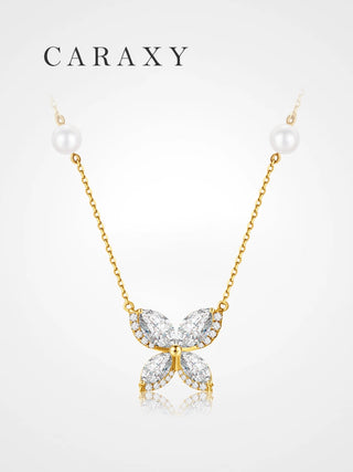 Front view of an 18K yellow gold butterfly diamond necklace with pearl stations