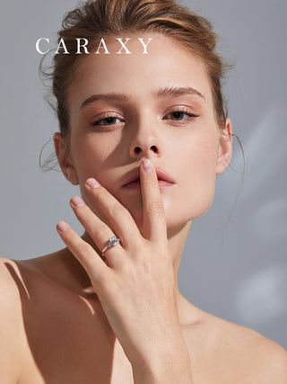 Lifestyle view of a model wearing CARAXY emerald cut three-stone diamond ring.