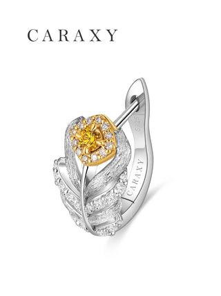 Close-up of a fancy yellow lab-grown diamond with a white diamond halo on a feather-inspired earring