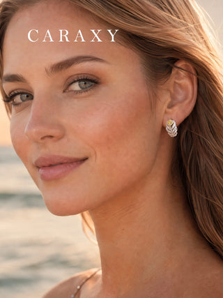 Close-up of feather-inspired yellow and white lab-grown diamond earrings worn on the ear