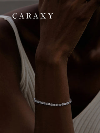 Mixed-cut lab-grown diamond tennis bracelet worn on the wrist in an editorial setting