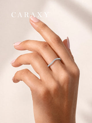 18K white gold diamond wave wedding band worn alone on the hand