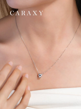 Model wearing a cat diamond pendant necklace in 18K white gold with a bezel set round lab grown diamond.