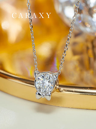 Close-up of a cat diamond pendant necklace in 18K white gold with a bezel set lab grown diamond.