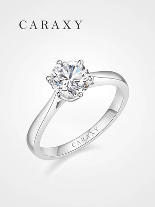 A classic cathedral six prong solitaire engagement ring featuring a tapered band in 18K white gold.