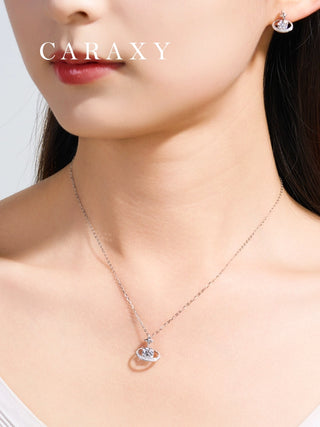 Model wearing a celestial round diamond pendant necklace in 18K white gold with matching earrings from the same series.