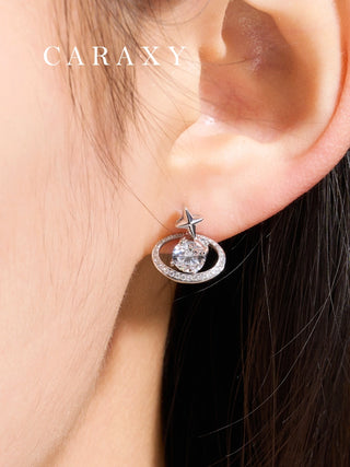 Celestial diamond studs shown on the ear with star and orbit-inspired details.