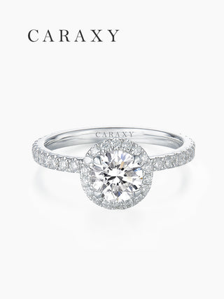 Top view of a classic halo engagement ring with half pavé diamond band by CARAXY.