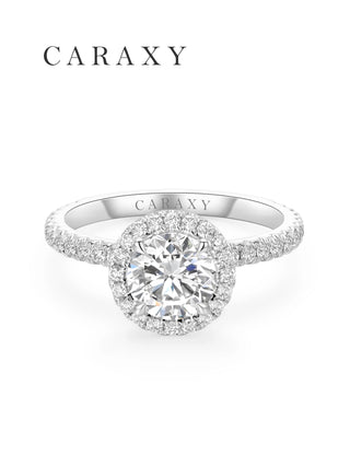 Top view of a classic halo engagement ring with half pavé diamond band by CARAXY.