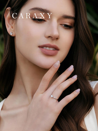 Lifestyle view of a model wearing a classic nature-inspired side stone engagement ring.
