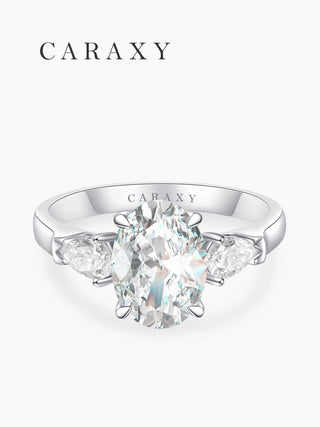 Top view of a classic three-stone engagement ring with an elongated oval center stone.