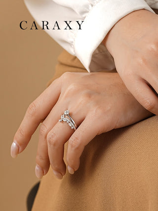 Woman wearing an 18K white gold contour diamond wedding band stacked with an engagement ring