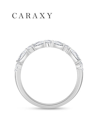 Side profile of an 18K white gold contour wedding band with an elevated top diamond design
