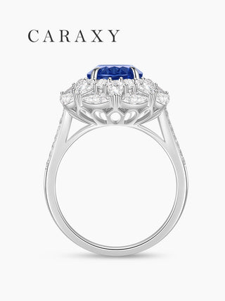 Side view of cornflower sapphire ring with diamond halo.