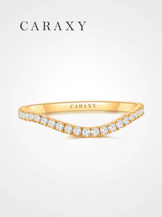 Front view of a curved half-pavé lab-grown diamond wedding band in 18K yellow gold.