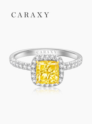 Top view of a fancy yellow cushion cut diamond ring with a shimmering pavé halo.