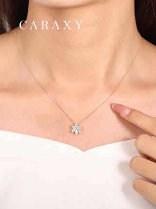 Model wearing floral jewelry pear cut diamond necklace.